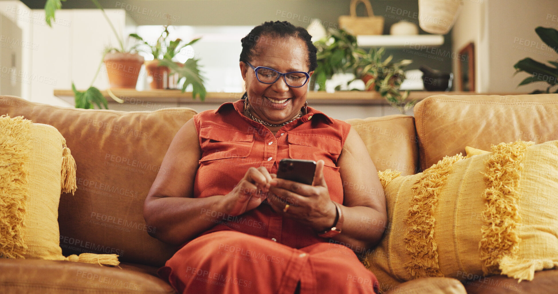 Buy stock photo Home, senior woman and smartphone with typing, connection and chatting in living room. African person, apartment and lady with cellphone, mobile user and internet with message, social media and text