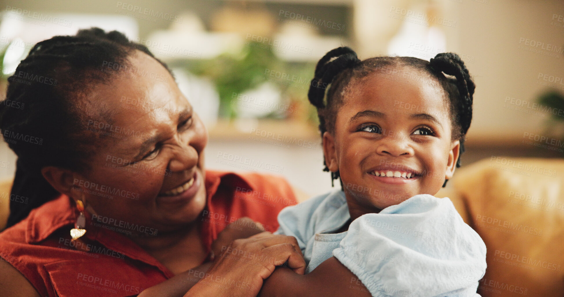 Buy stock photo Happy, grandmother and child laughing at house for bonding, love and care together of family support. Smile, senior black woman and girl with embrace for funny joke, comic meme, retirement and lounge