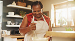 Baking, home and black woman with bowl in kitchen for cake, muffins or dessert for party at home. Happy, mix and mature African female person with utensil for preparing dough or bread recipe at house