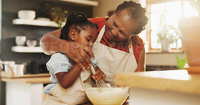 Buy stock photo Baking, black child and grandmother in kitchen for support, recipe process and mixing batter at home. Young girl, development or senior woman at counter for trust, growth or encouragement making cake