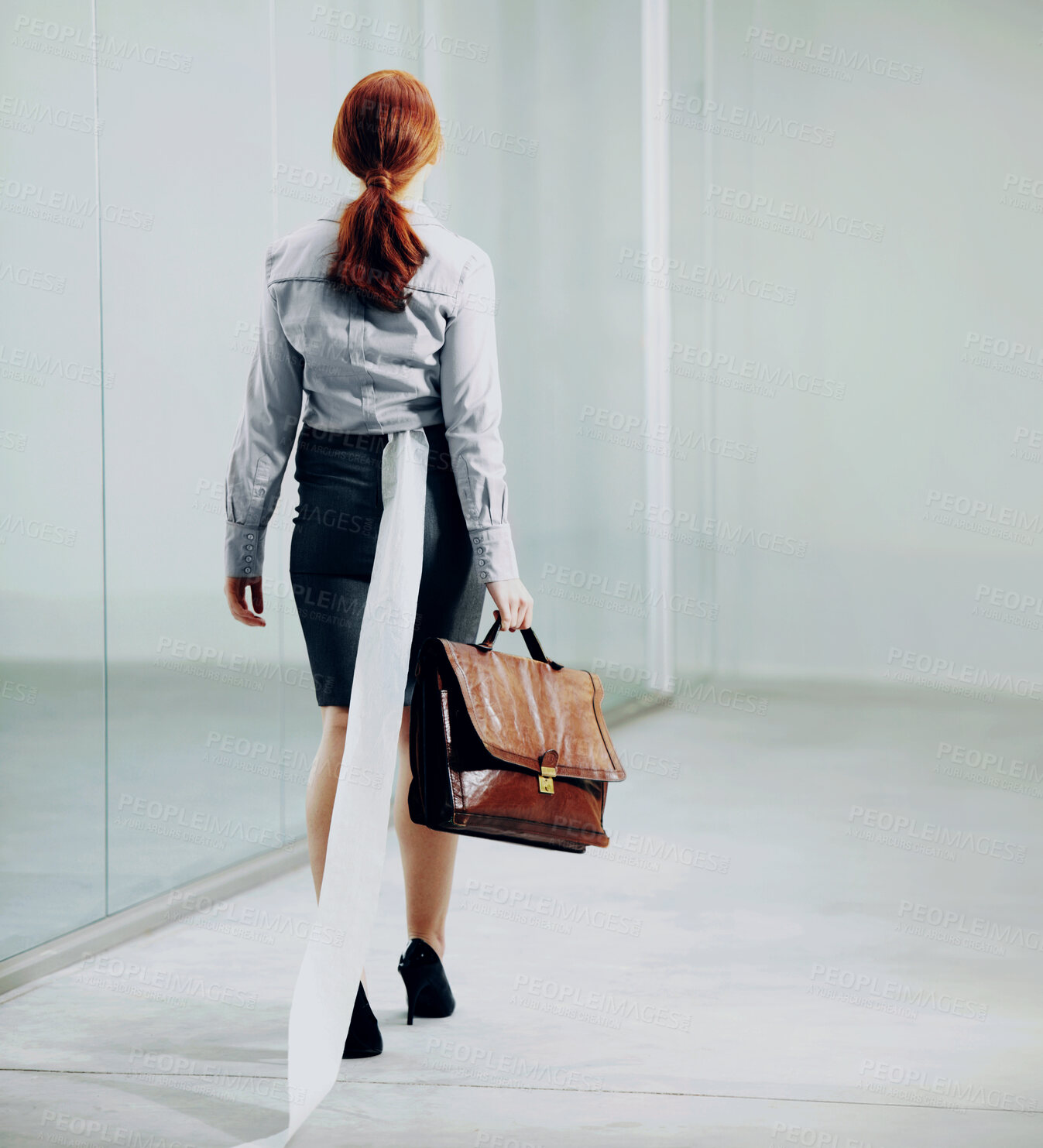 Buy stock photo A young businesswoman carrying a satchel with toilet paper stuck in her skirt