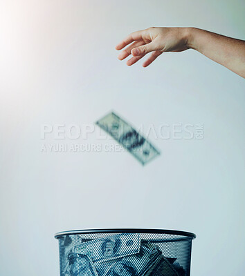 Buy stock photo Dustbin, money or bills with finance, inflation or debt with bankruptcy, trash or global recession. Waste bucket, cash or economy issues with fraud, corruption or value decline on a studio background