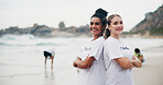 Team, portrait and volunteer at beach for cleaning, recycling and environment sustainability with smile. Woman, ngo and crossed arms by ocean for community service, charity and cleanup collaboration