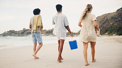 Buy stock photo Friends, back and walking on beach for picnic with basket, beer and fun on travel vacation in summer. Men, girl and together by ocean with alcohol for drinking, conversation and bonding on holiday.