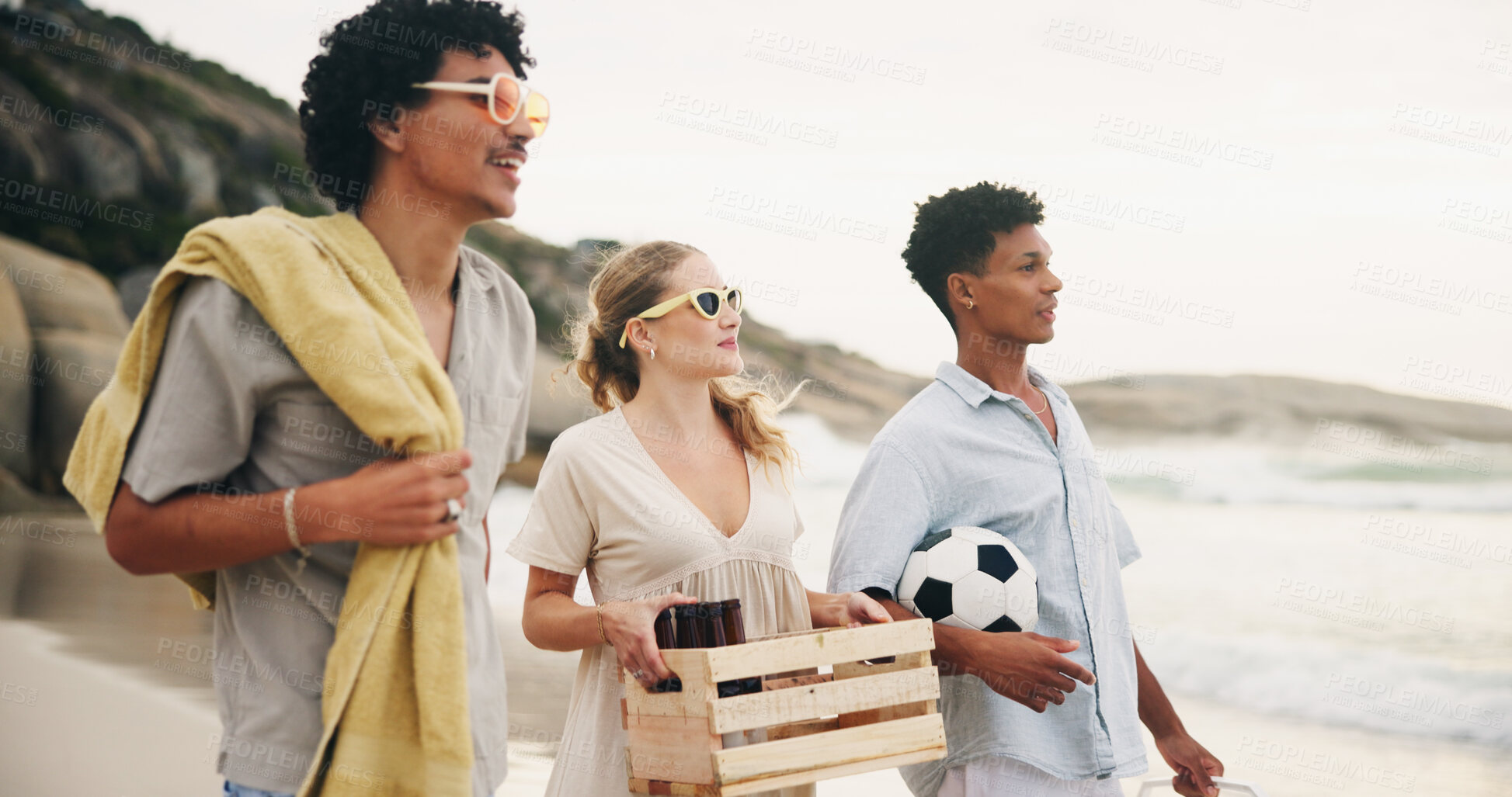 Buy stock photo Friends, smile and walking on beach for picnic with basket, beer and fun on travel vacation in summer. Men, girl and together by ocean with alcohol for drinking, conversation and bonding on holiday.