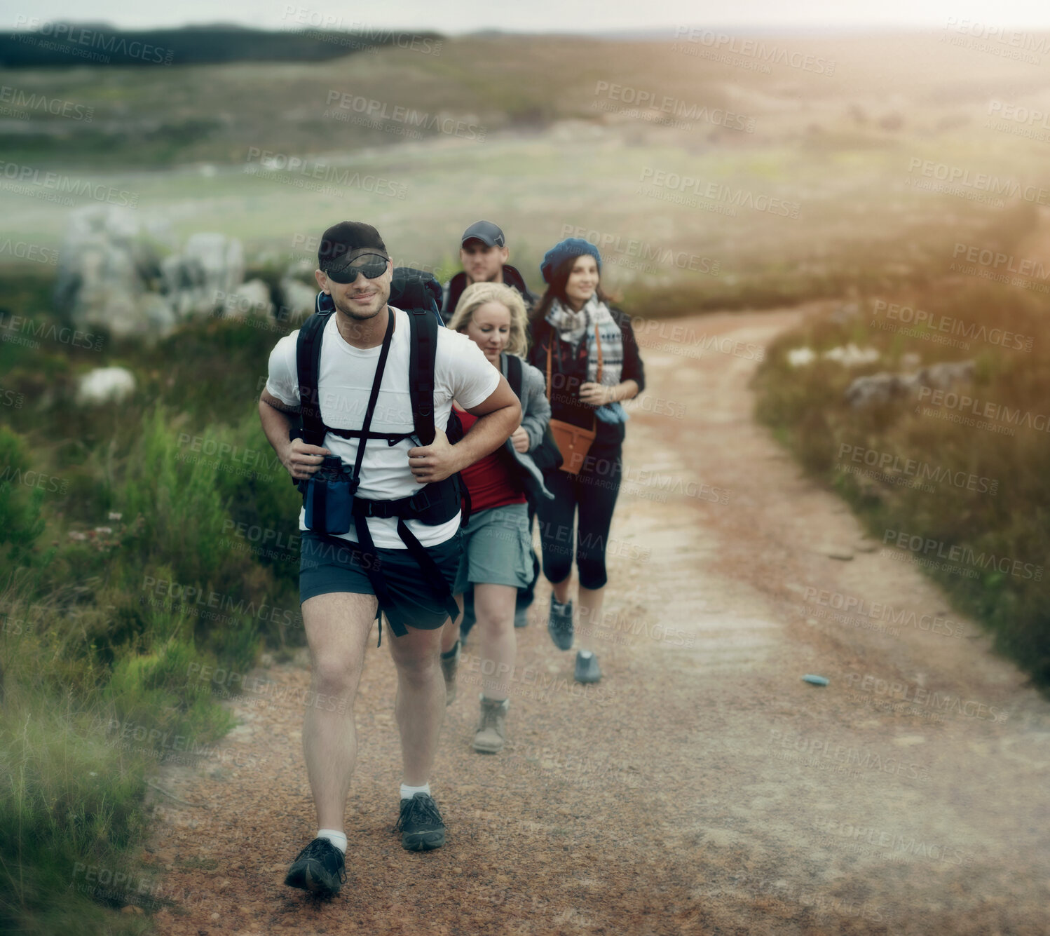 Buy stock photo A happy group of friends walking the hiking trails together