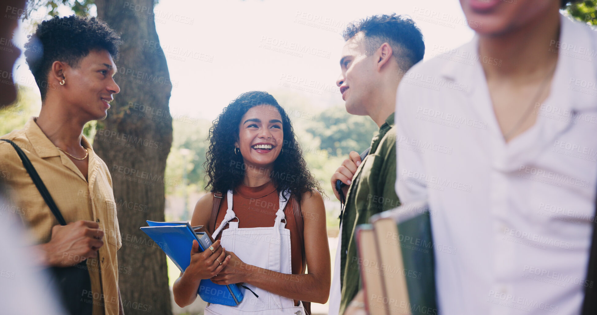 Buy stock photo Students, campus and friends talking in park for break, funny conversation and study chat. Joke, learning and happy people with backpack, smile or discussion in college for school education together