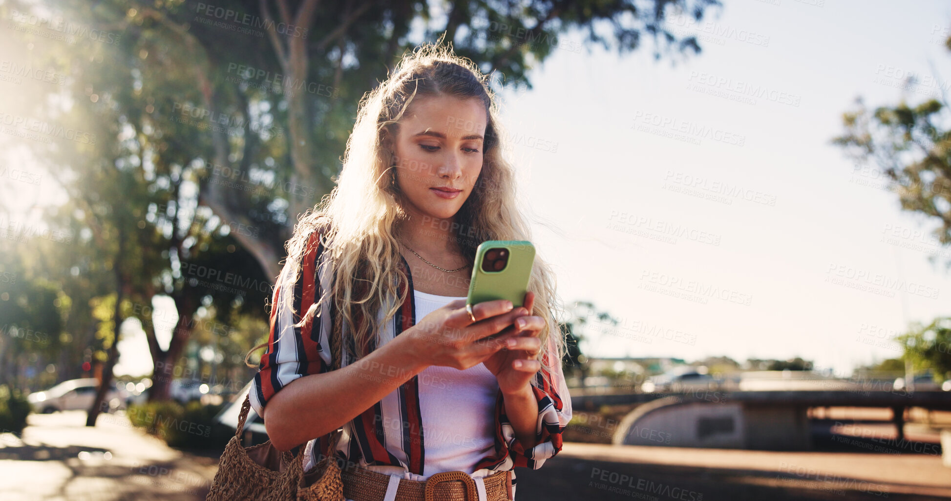 Buy stock photo Girl, phone and typing outdoor for social media, communication and travel while chatting with chat. Female person, smartphone and walking in city for networking, email and mobile app with message
