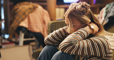 Buy stock photo Woman, sad and neck pain on floor in home, thinking and depression for chaos, worry and clothes in living room. Person, injury and anxiety with mess in lounge, apartment and mental health in Germany