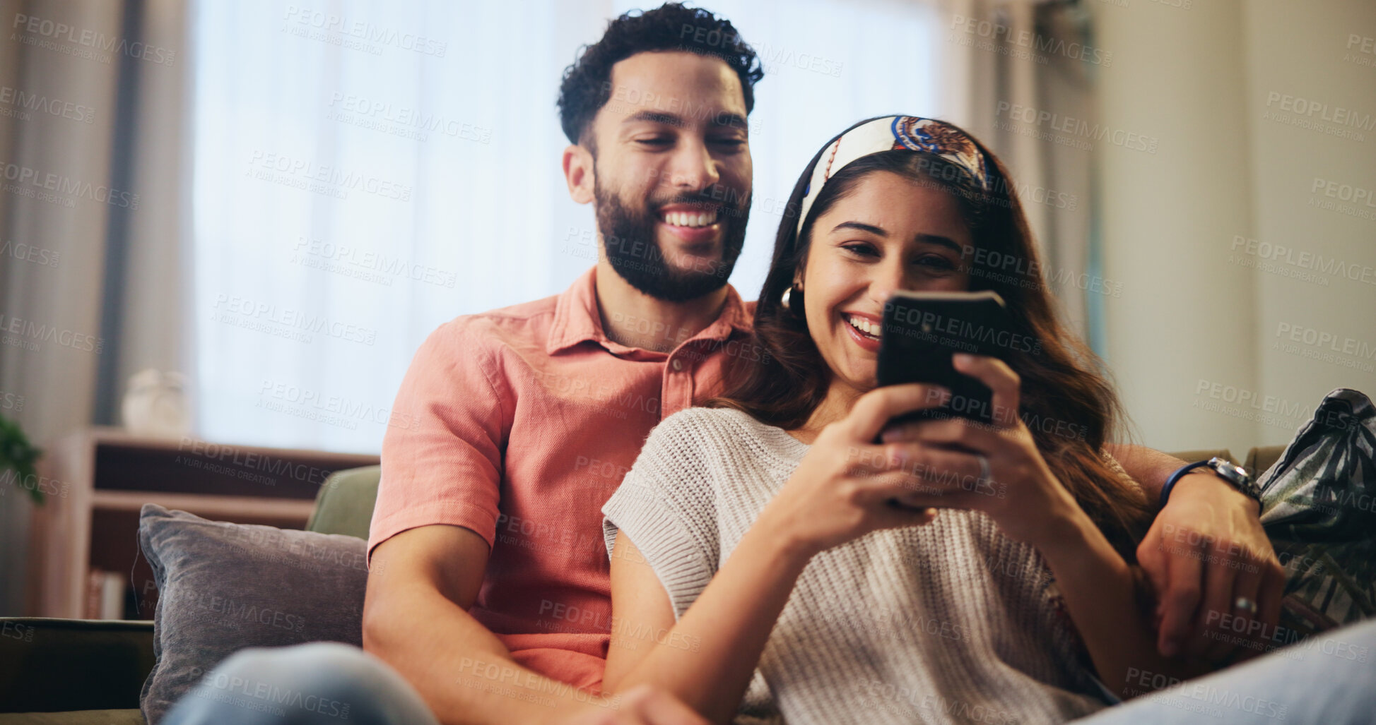 Buy stock photo Happy, love and couple on sofa with phone for bonding, loving relationship and laugh together in home. Relax, apartment and man with woman embrace on smartphone for social media, website and internet