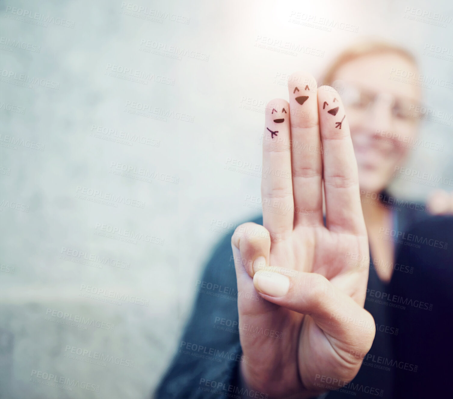 Buy stock photo Cropped shot of fingers with smileys drawn on them