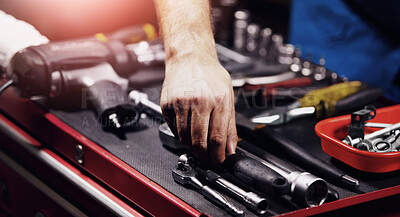 Buy stock photo Hand of a mechanic doing repairs after reaching for a wrench from his toolbox. Blue collar worker with the tool to fix your vehicle, perform a service or do maintenance. 