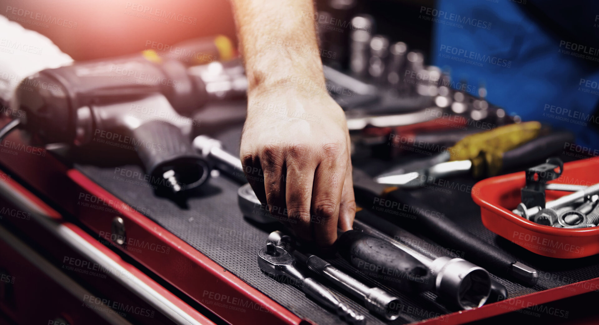 Buy stock photo Hand of a mechanic doing repairs after reaching for a wrench from his toolbox. Blue collar worker with the tool to fix your vehicle, perform a service or do maintenance. 