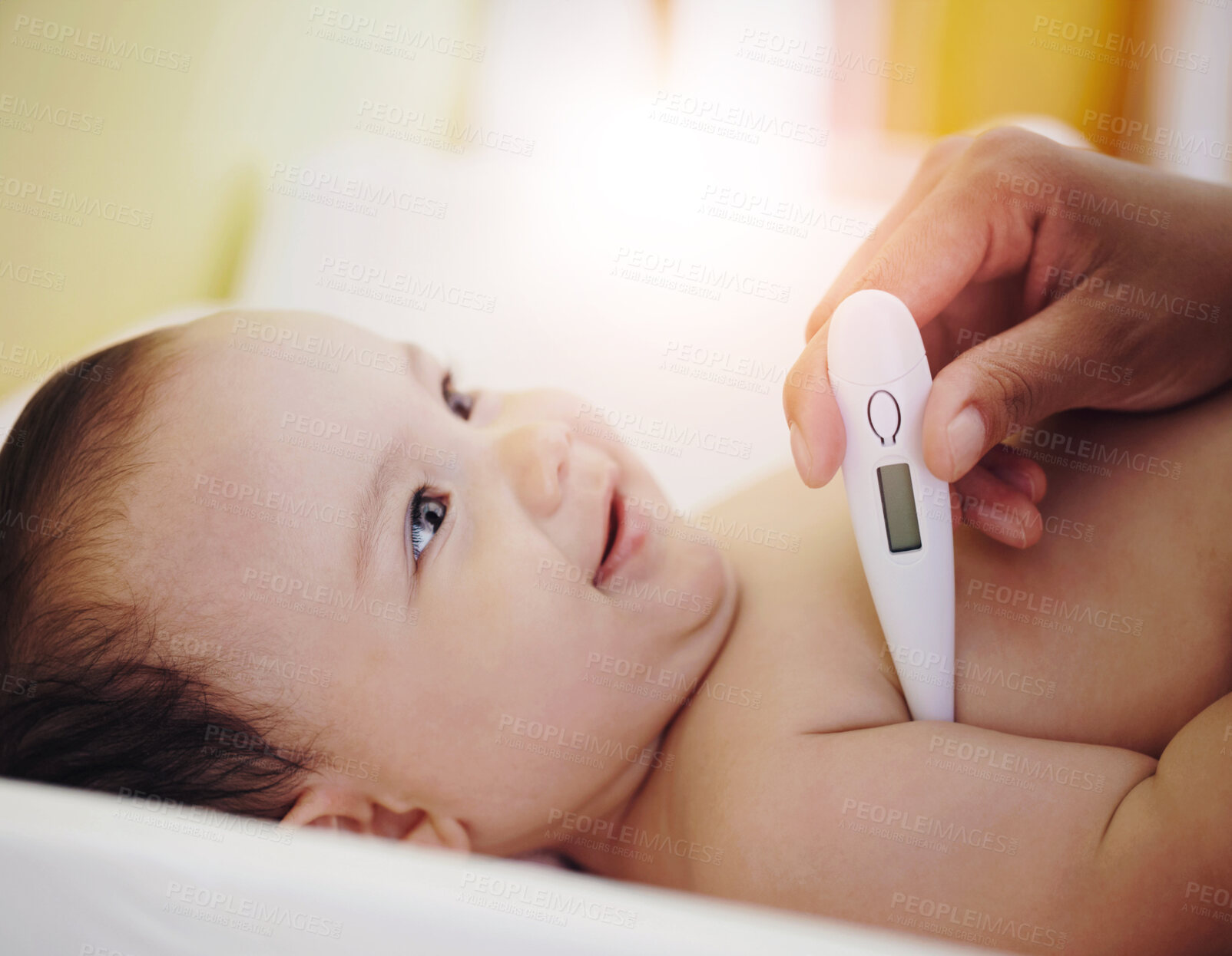 Buy stock photo A smiling baby girl looking up as her mother is taking her temperature