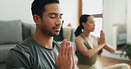 Couple, man and namaste with meditation in home for holistic wellness, mindfulness and relax on floor with zen. People, praying hands and spiritual healing in living room for yoga, pilates or bonding