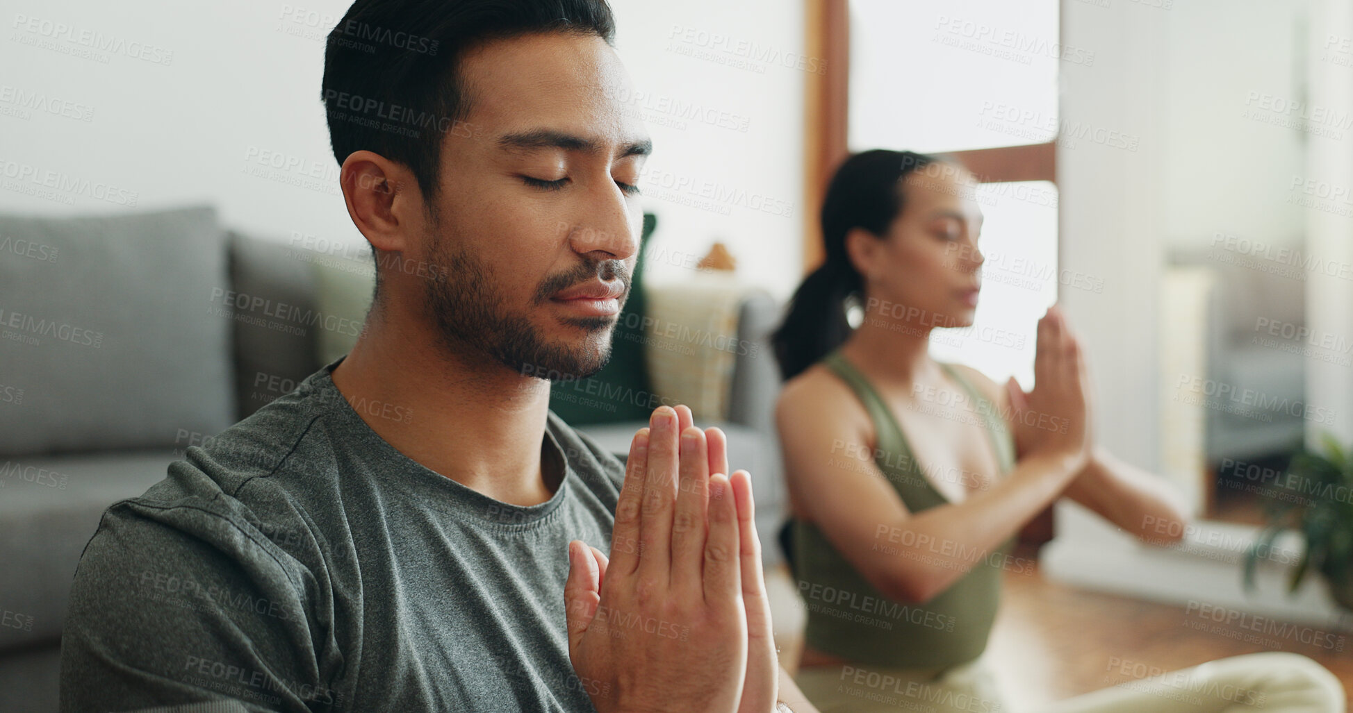 Buy stock photo Couple, man and namaste with meditation in home for holistic wellness, mindfulness and relax on floor with zen. People, praying hands and spiritual healing in living room for yoga, pilates or bonding