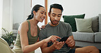 Online shopping, phone and happy couple talking in home for social media, choice and payment. Man, woman and mobile in living room for conversation, account review and check credit score on internet