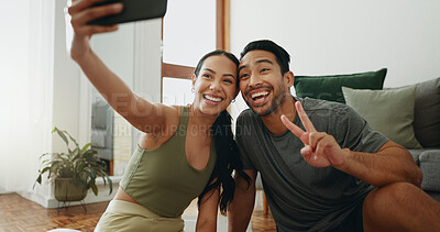 Buy stock photo Happy couple, fitness and selfie with picture for workout, exercise or indoor training together at home. Young woman and man with peace sign, emoji or smile for photography, memory or moment at house