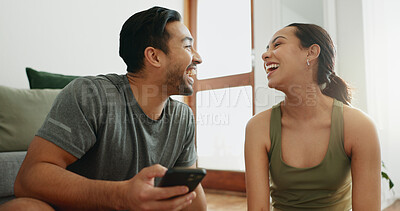 Buy stock photo Laughing, phone and happy couple in home for funny meme, comedy or comic. Man, woman and joke with mobile in living room for conversation or watch video on internet together on social media platform