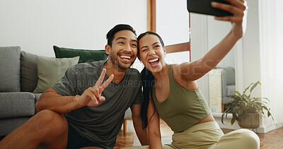 Buy stock photo Happy couple, fitness and selfie with peace sign for workout, exercise or indoor training together at home. Young woman and man with emoji or smile for photography, memory or picture moment at house