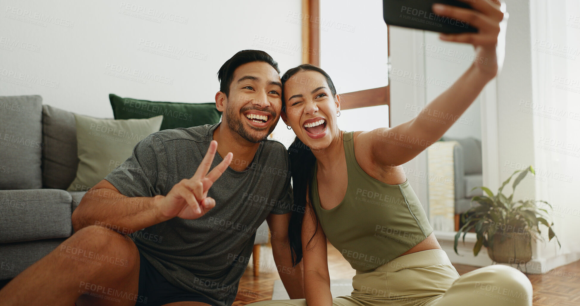 Buy stock photo Happy couple, fitness and selfie with peace sign for workout, exercise or indoor training together at home. Young woman and man with emoji or smile for photography, memory or picture moment at house