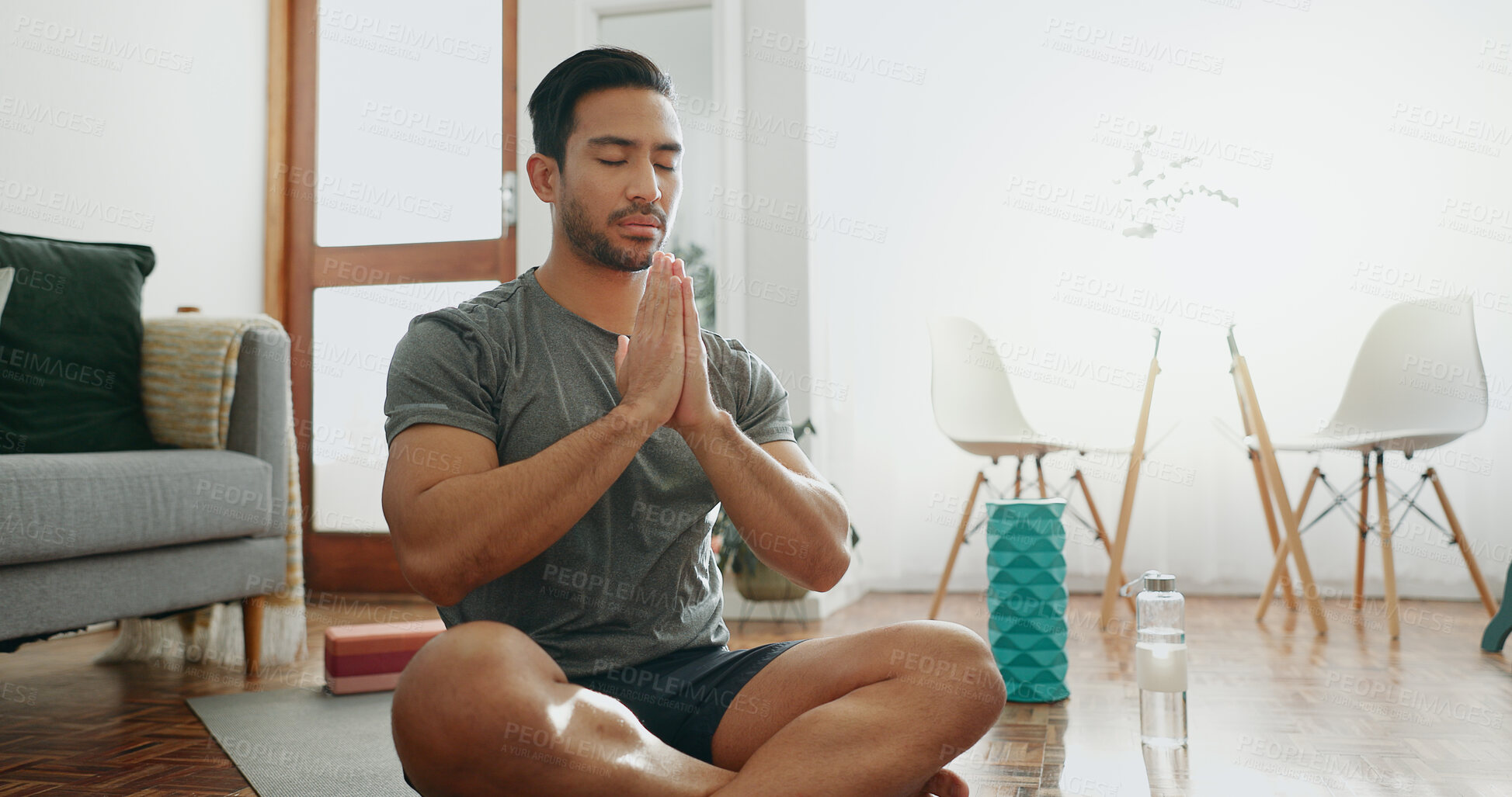 Buy stock photo Home, meditation and man with fitness, yoga and chakra with hobby, routine and wellness. Healthy person, apartment and yogi with water bottle, zen and calm with peace, positive energy and awareness