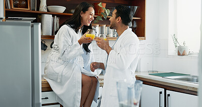 Buy stock photo Couple, happy and love in kitchen with orange juice, happiness and fun in relationship. Man, woman and drink in home for conversation, bonding and relax in morning or excited for anniversary or trust