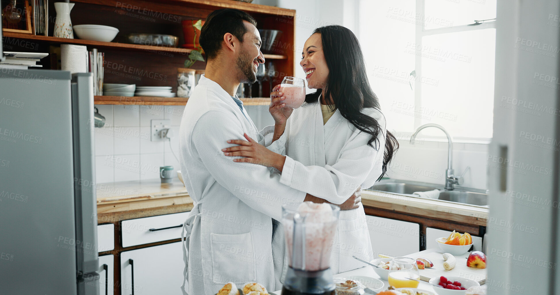 Buy stock photo Couple, happy and love in kitchen with smoothie, healthy breakfast or fun in relationship. Man, woman and drink in home for nutrition, bonding and relax in morning or excited for anniversary or trust