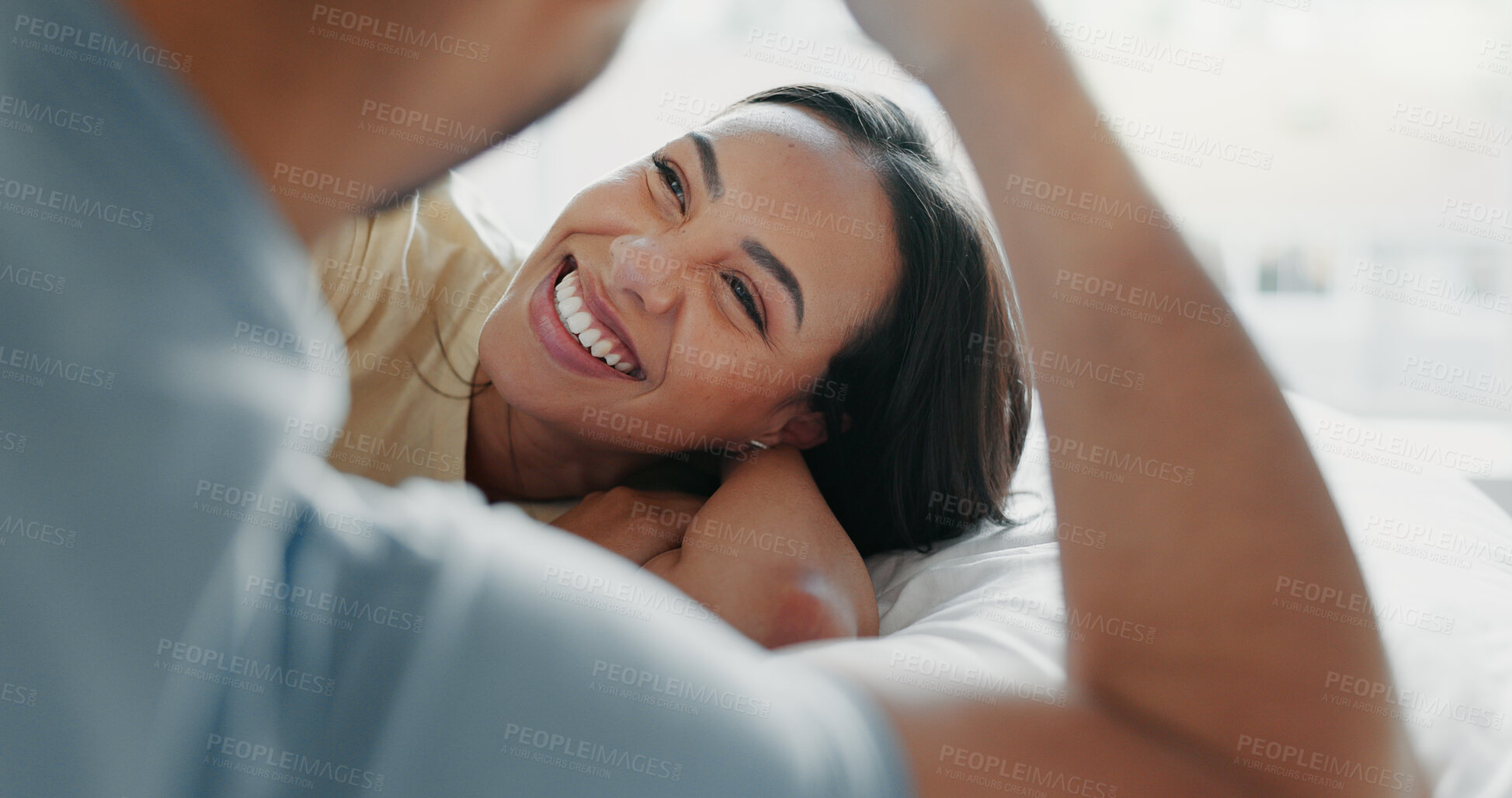 Buy stock photo Couple, relax and smile on bed for love, romance and funny storytelling in home. Man, woman and laugh in bedroom with trust, commitment and enjoy weekend sleep in with fun, joke and good memories