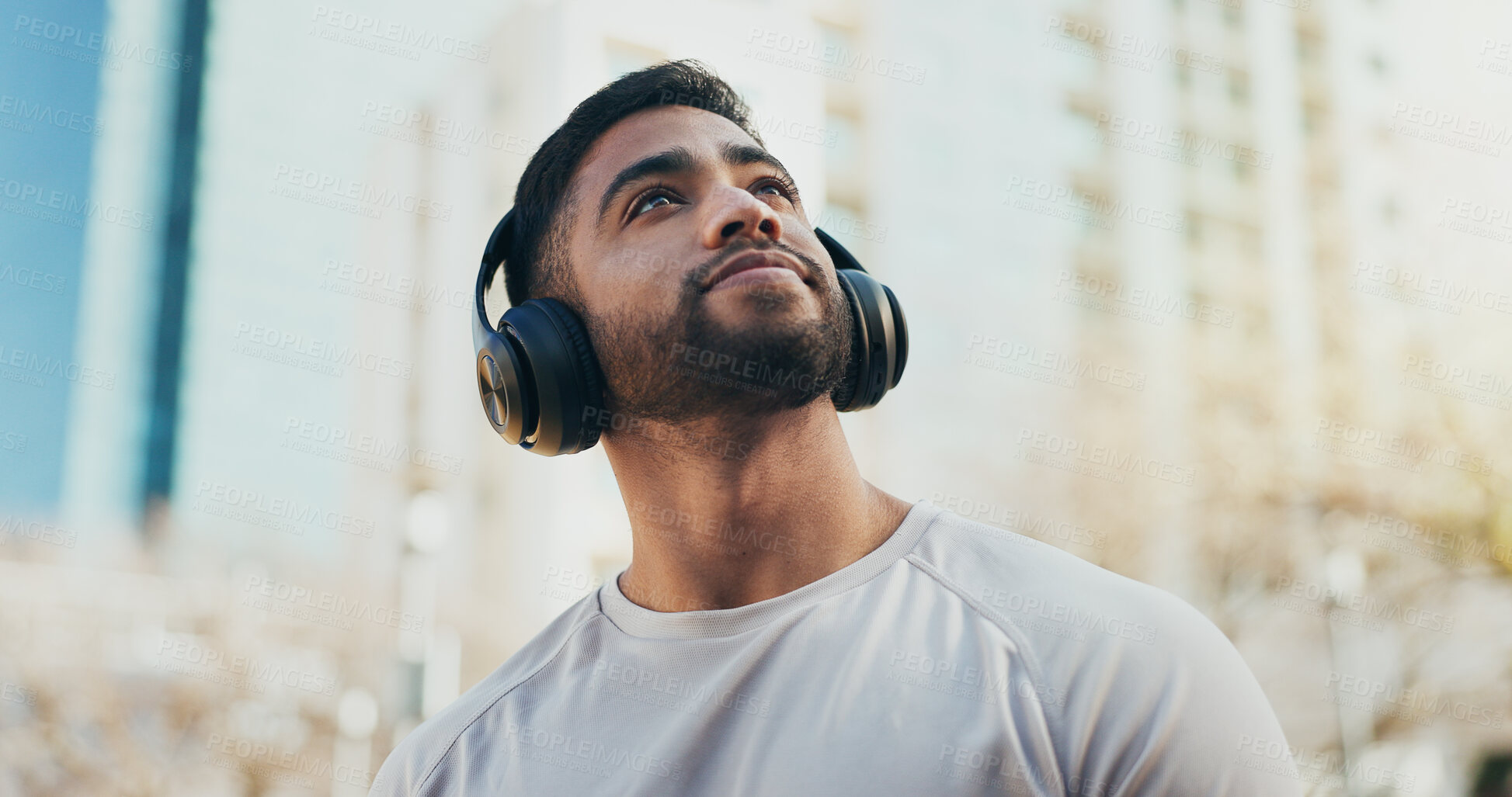 Buy stock photo Sports, headphones and man in city for running, workout or training for race endurance or stamina. Thinking, fitness and male athlete with audio tech for podcast, music or radio with cardio exercise.