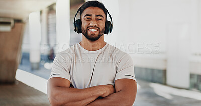 Buy stock photo Fitness, headphones and man in city for portrait, confidence and happy for workout progress. Smile, music or athlete on street with arms crossed, muscular or break from marathon preparation in town