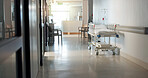 Empty, hospital and interior with bed in lobby for inpatient care, recovery and health insurance. Clinic, gurney and space in room with furniture for emergency, medical service and rehabilitation