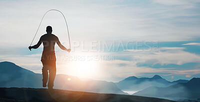 Buy stock photo Rearview of a man skipping on a mountain top