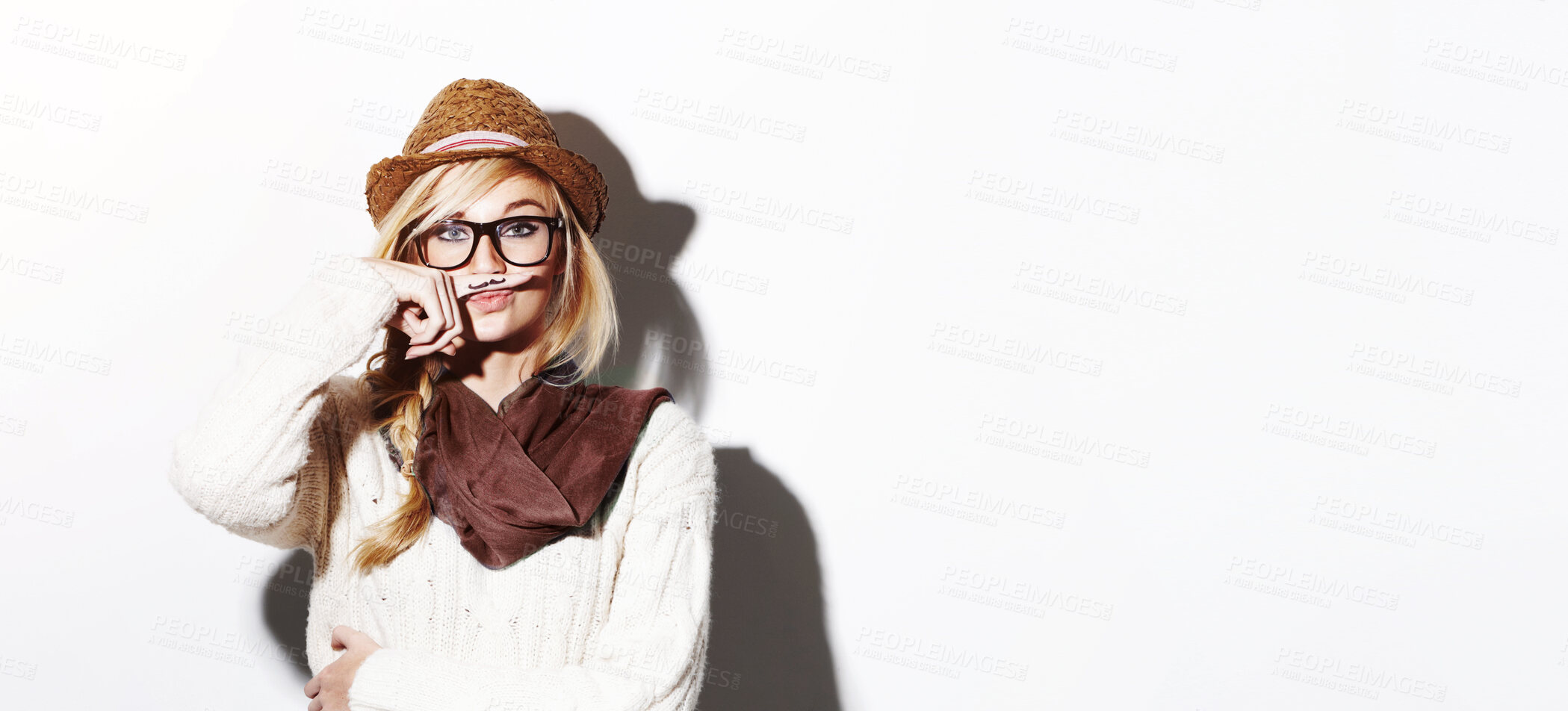 Buy stock photo Portrait, hipster and isolated girl with moustache on index finger, nerd glasses and fun pose on studio white background. Young woman, modern fashion and mustache joke or goofy, weird and photobooth