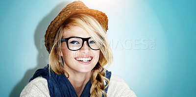 Buy stock photo Studio, portrait and trendy woman with glasses, smile and casual fashion on mockup space. Laugh, relax and happy face of gen z girl with cool style, student and fun hipster culture on blue background