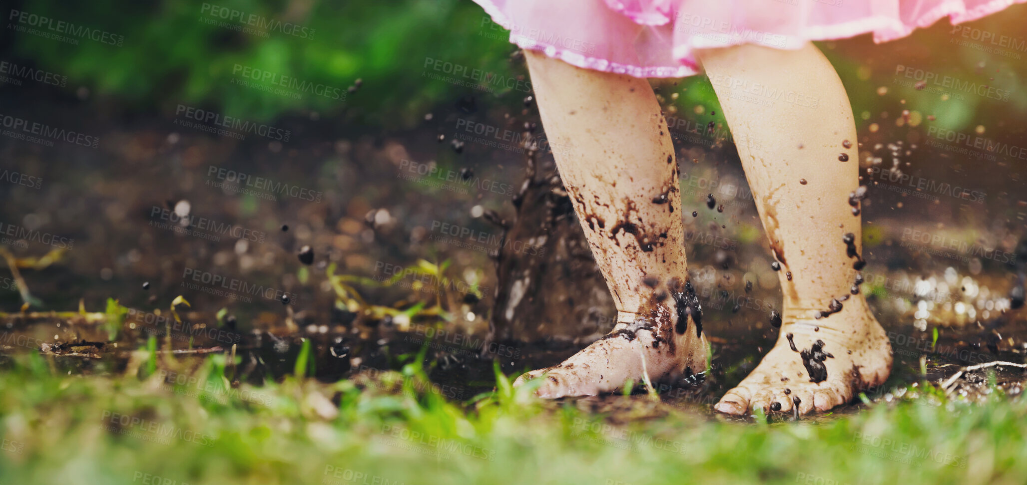 Buy stock photo Shot of a little girl playing outside in the mud