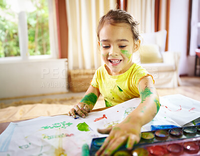 Buy stock photo shot of a mischievous child making a mess while painting