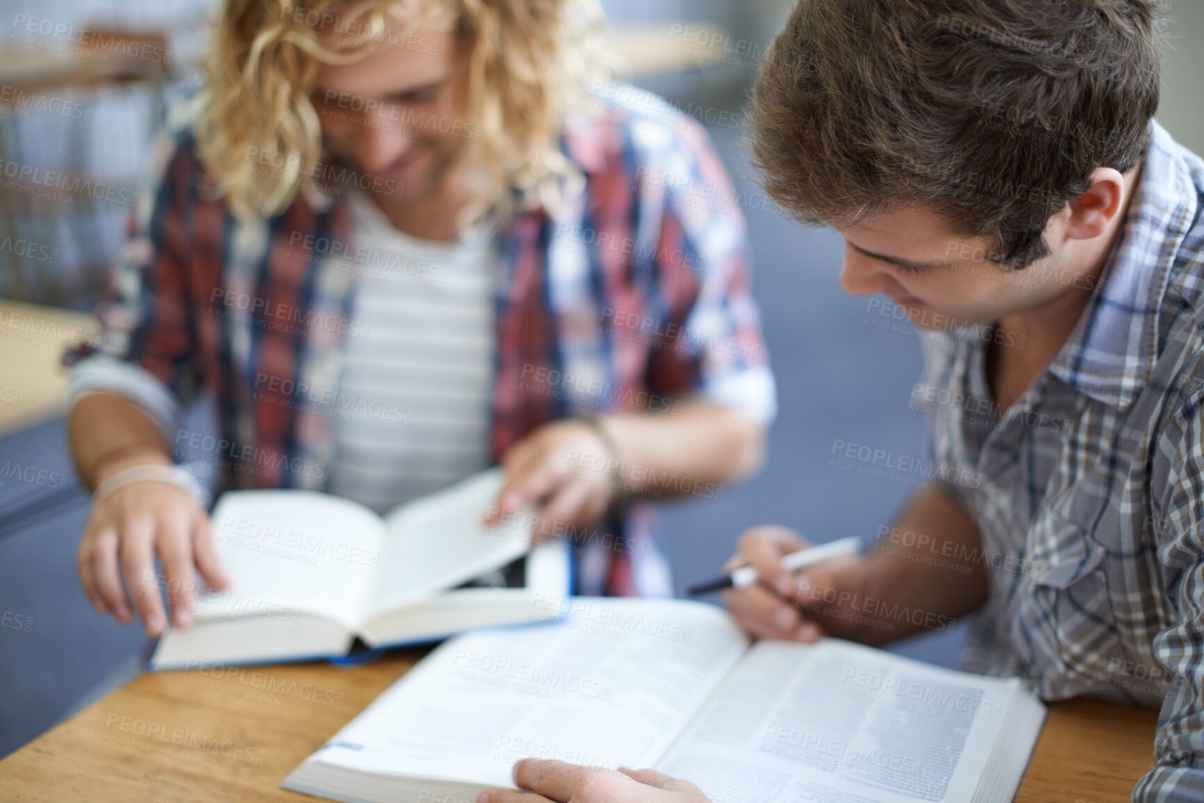 Buy stock photo Men, students and reading from textbook in university classroom for group work, education or research. Male people, friends and college lecture for test information or together, knowledge or learning