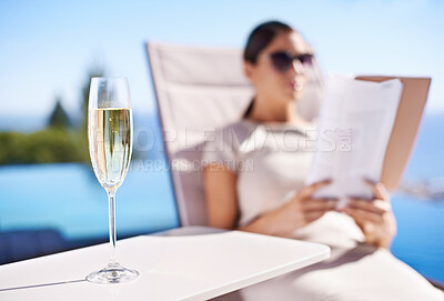 Buy stock photo Relax, pool and woman with champagne, magazine and reading in lounge chair on business trip. Travel, hospitality and businesswoman on deck with wine, book and sunshine holiday at luxury villa hotel