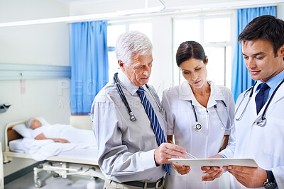 Buy stock photo Doctors, group and people in discussion with report or results for sick patient in clinic. Healthcare, medical professional or collaboration with chart for advice, planning or help with mature mentor