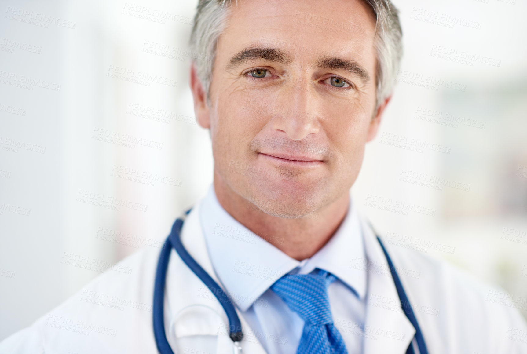 Buy stock photo Mature doctor, man and portrait in clinic for healthcare, advice and consulting services. Person, medic and smile with pride for career with wellness, care and confidence at hospital in Switzerland