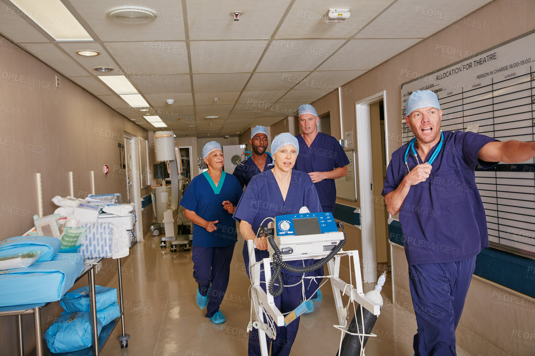 Buy stock photo Shot of a medical team rushing through a hospital corridor