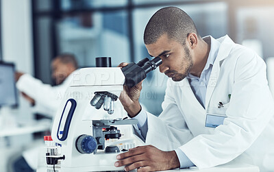 Buy stock photo Cropped shot of a young male scientist working in his lab