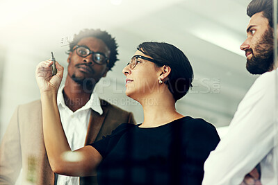 Buy stock photo Cropped shot of a group of businesspeople brainstorming with notes on a glass wall in an office