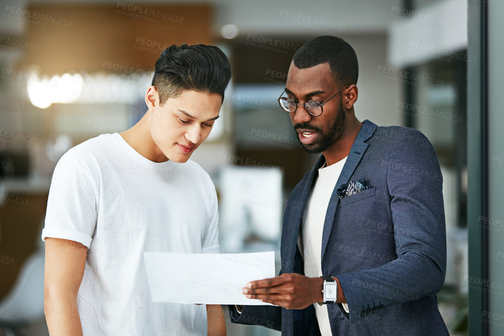 Buy stock photo Manager, leader or mentor talking to an intern, employee and training while giving feedback on a document. Business man discussing ideas and strategy with his junior marketing assistant at work