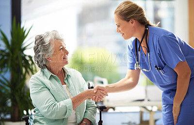 Buy stock photo Shot of a doctor shaking hands with a smiling senior woman sitting in a wheelchair