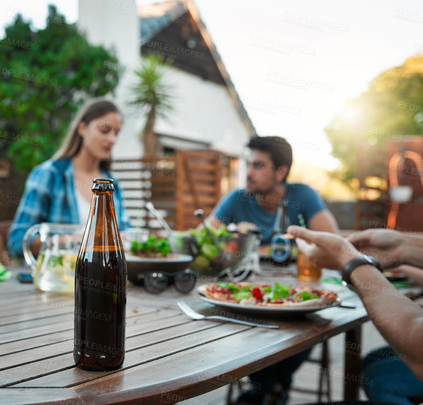 Buy stock photo Bottle, alcohol and friends in garden for dinner, lunch and bonding together with meal outdoor. Social gathering, people and beverage with food, healthy salad or hungry with nutrition for celebration