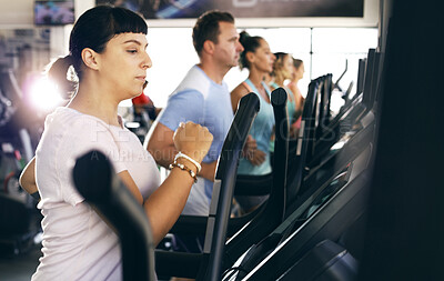 Buy stock photo Cropped shot of a group of young people working out on treadmills in the gym