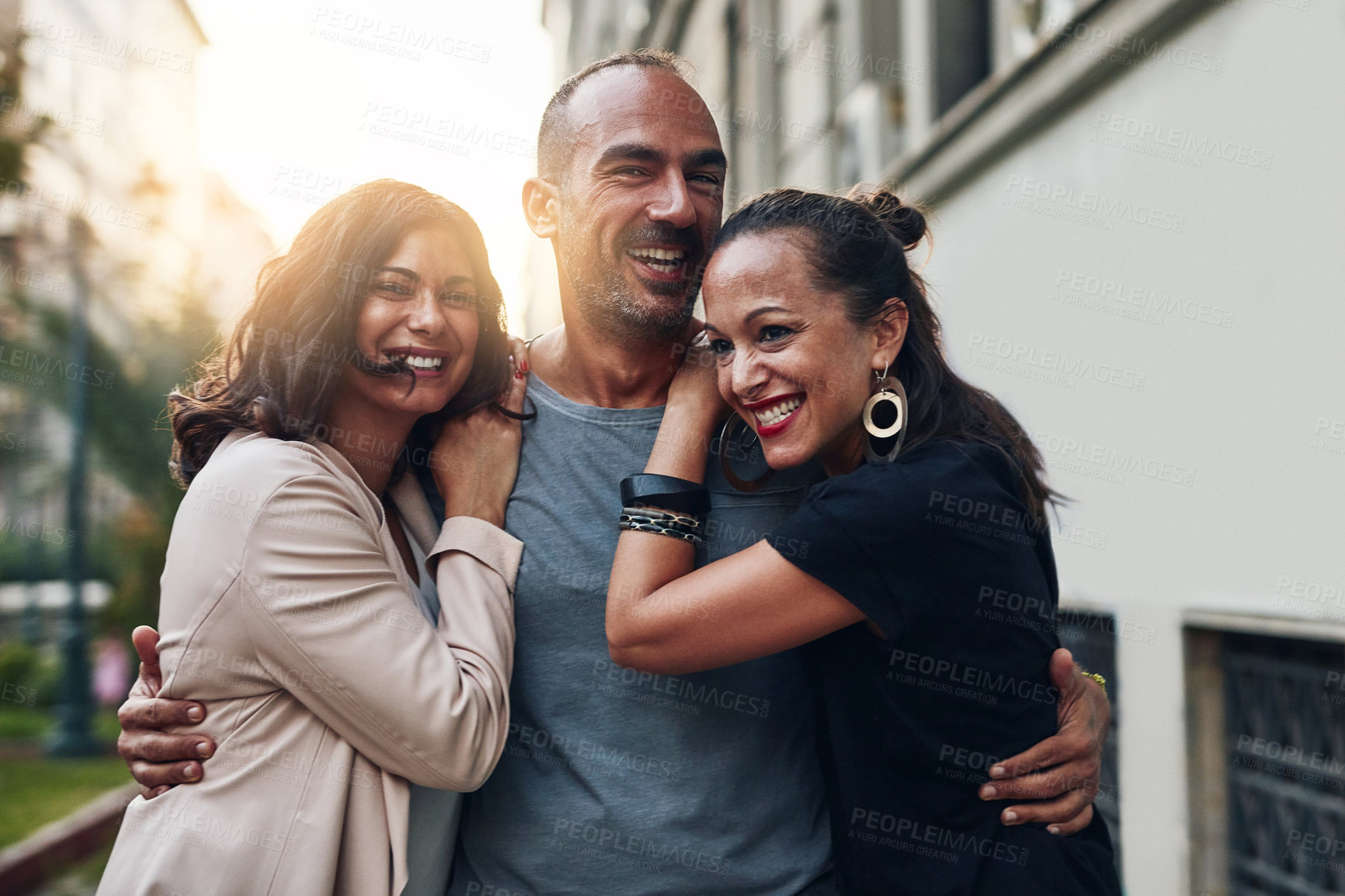 Buy stock photo Happy people, friends and city with hug for commute, travel or day out together in an urban town. Young, group and enjoying social, laughing or fun time for bonding, support or trust on sidewalk