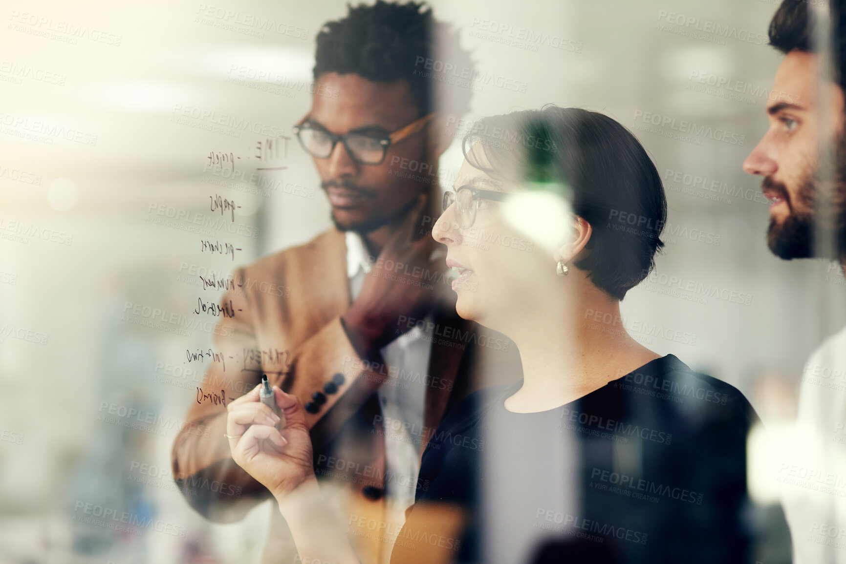 Buy stock photo Glass, leader and woman brainstorming with team or planning strategy for a startup company or small business. Teamwork, our vision and group of employees in a meeting for a idea of innovation